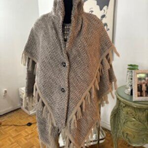 Fringed buttoned cape coat.